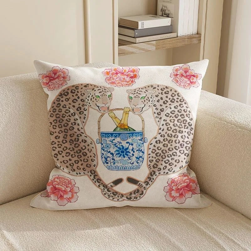 Decorative pillow with leopards and floral design on a beige couch