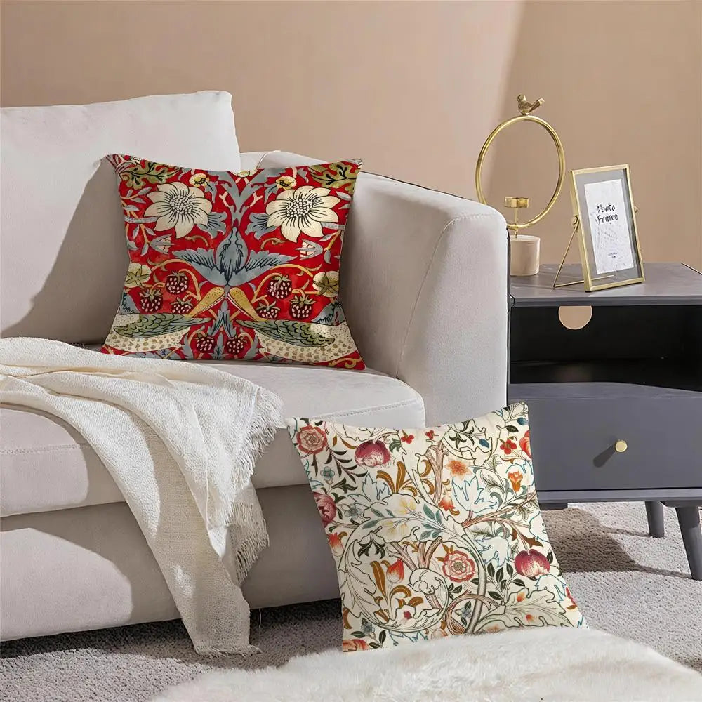 Decorative pillows with floral patterns on a sofa in a living room setting.