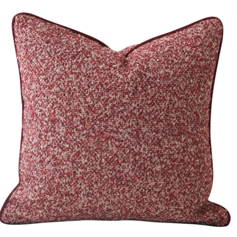Red and brown patterned pillow on a white background