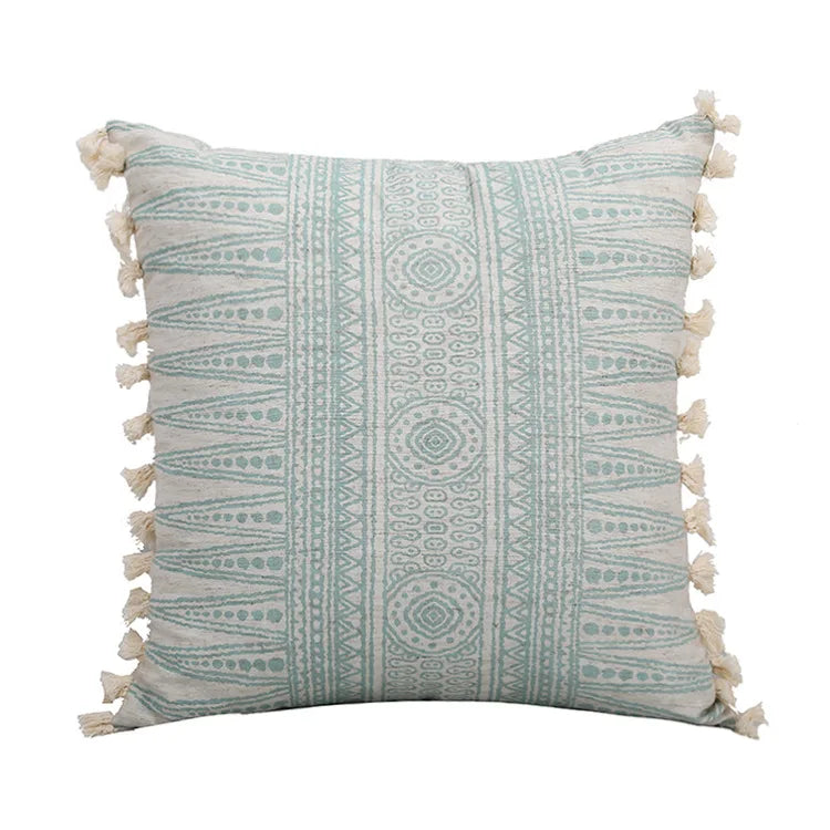 Decorative pillow with geometric pattern and tassels on a white background