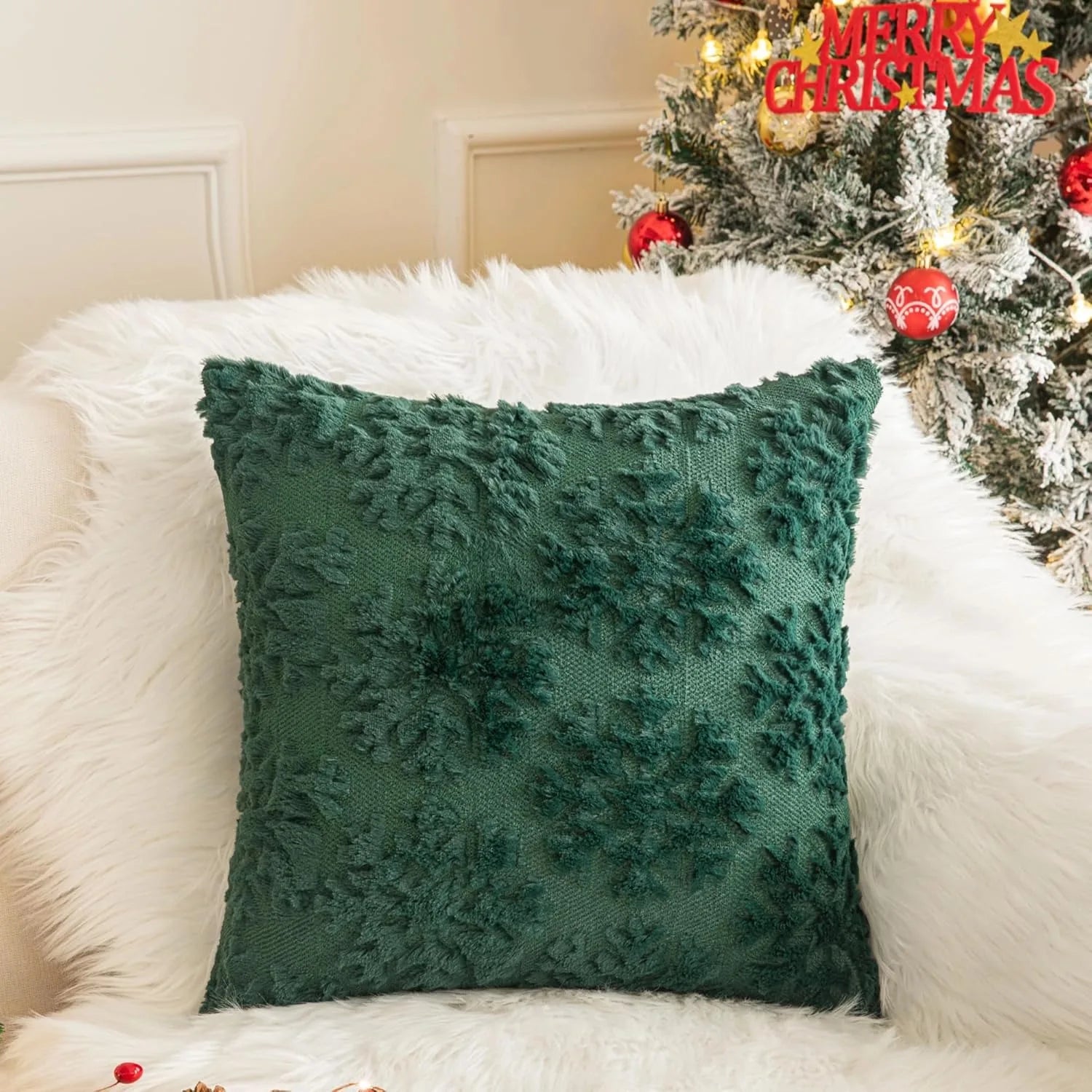 Green faux fur Christmas pillow cover with snowflake texture on festive sofa