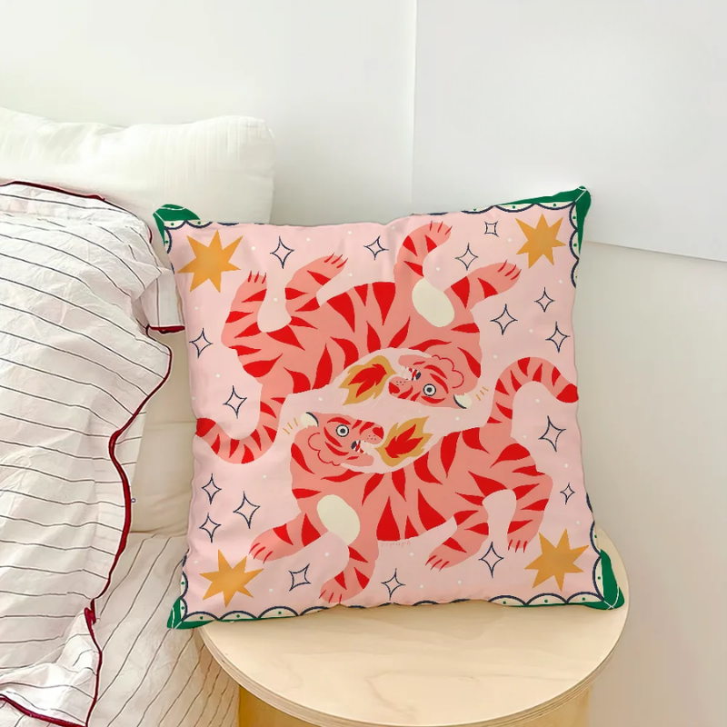 Pink cushion with illustrated tigers breathing fire among golden stars.