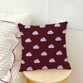 Decorative pillow with cloud pattern on a white couch