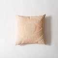 Decorative pink pillow with geometric pattern on a light gray background