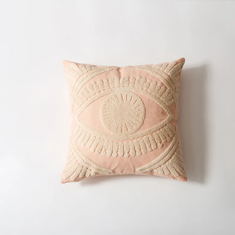 Decorative pink pillow with geometric pattern on a light gray background