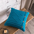 Nordic cable knit cushion cover in blue with diamond pattern and wooden button detail