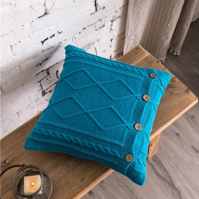 Nordic cable knit cushion cover in blue with diamond pattern and wooden button detail