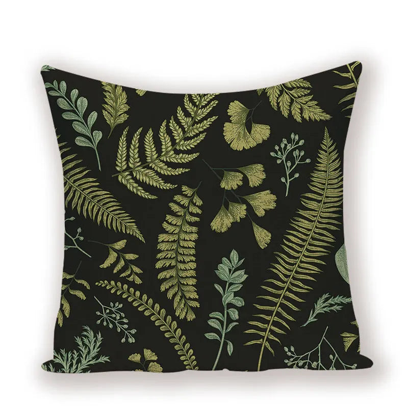Decorative pillow with green leaf pattern on a black background