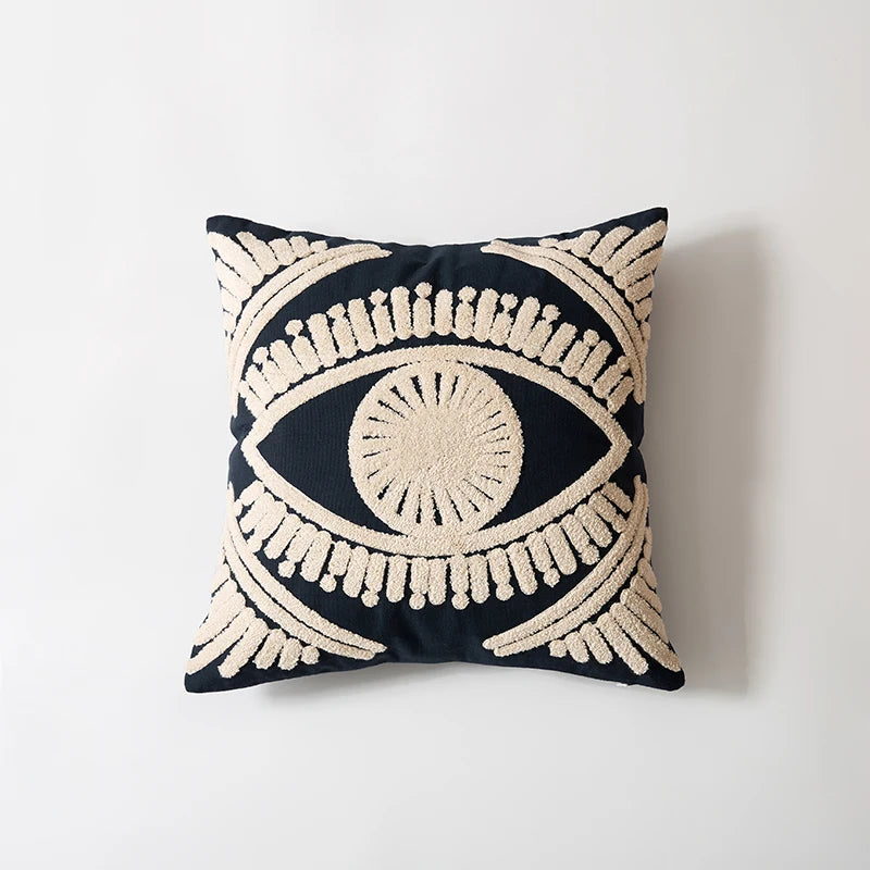 Decorative pillow with eye design on a plain background