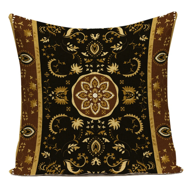 Decorative pillow with intricate gold patterns on a black background