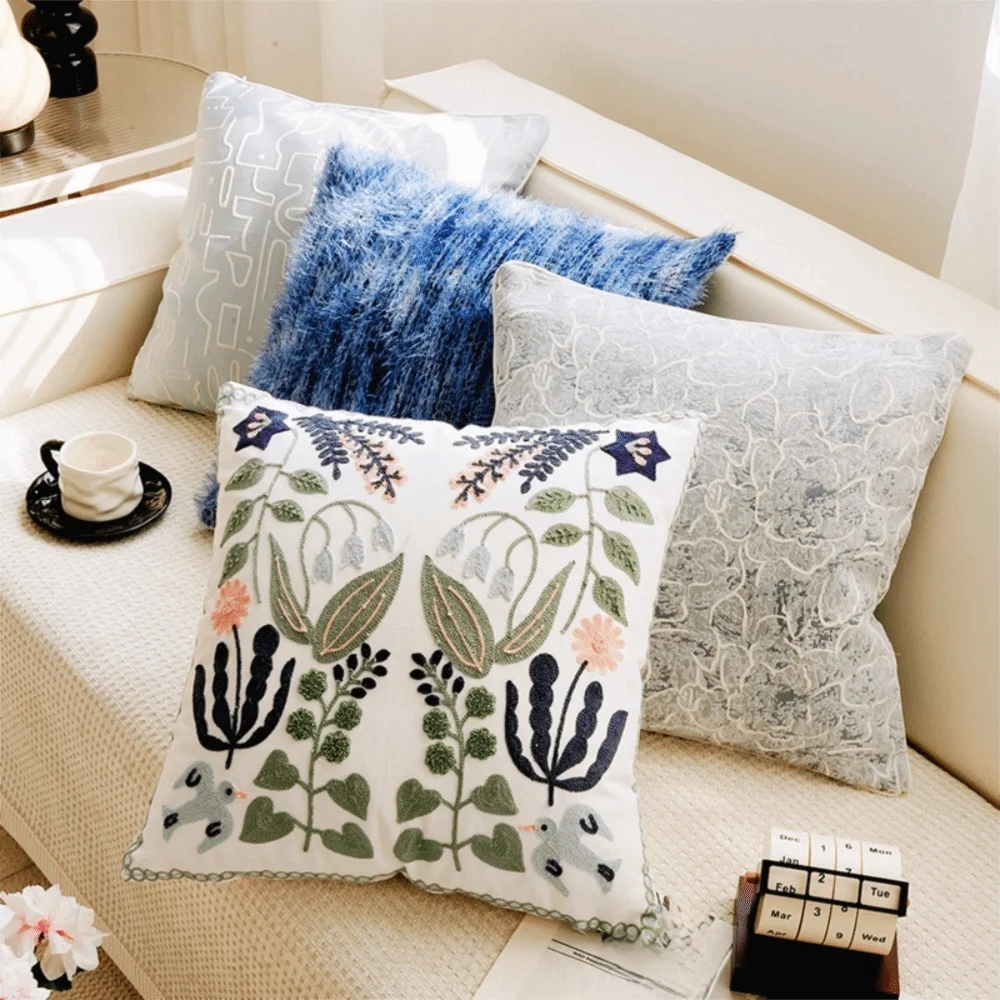 Decorative pillows on a sofa with floral and abstract patterns