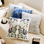 Decorative pillows on a sofa with floral and abstract patterns