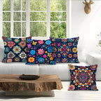 Colorful patterned pillows on a white sofa with a wooden coffee table in front of a window.