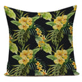 Decorative pillow with yellow floral and green leaf pattern on a black background
