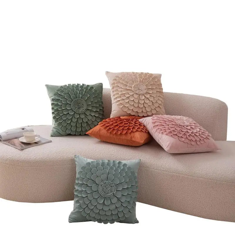 Set of velvet floral pillow covers in green, pink, and orange tones on modern sofa