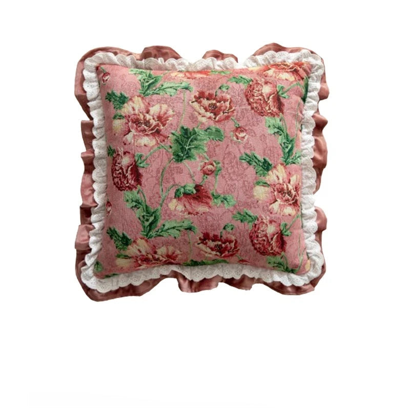 Floral patterned pillow with ruffled edge on a white background