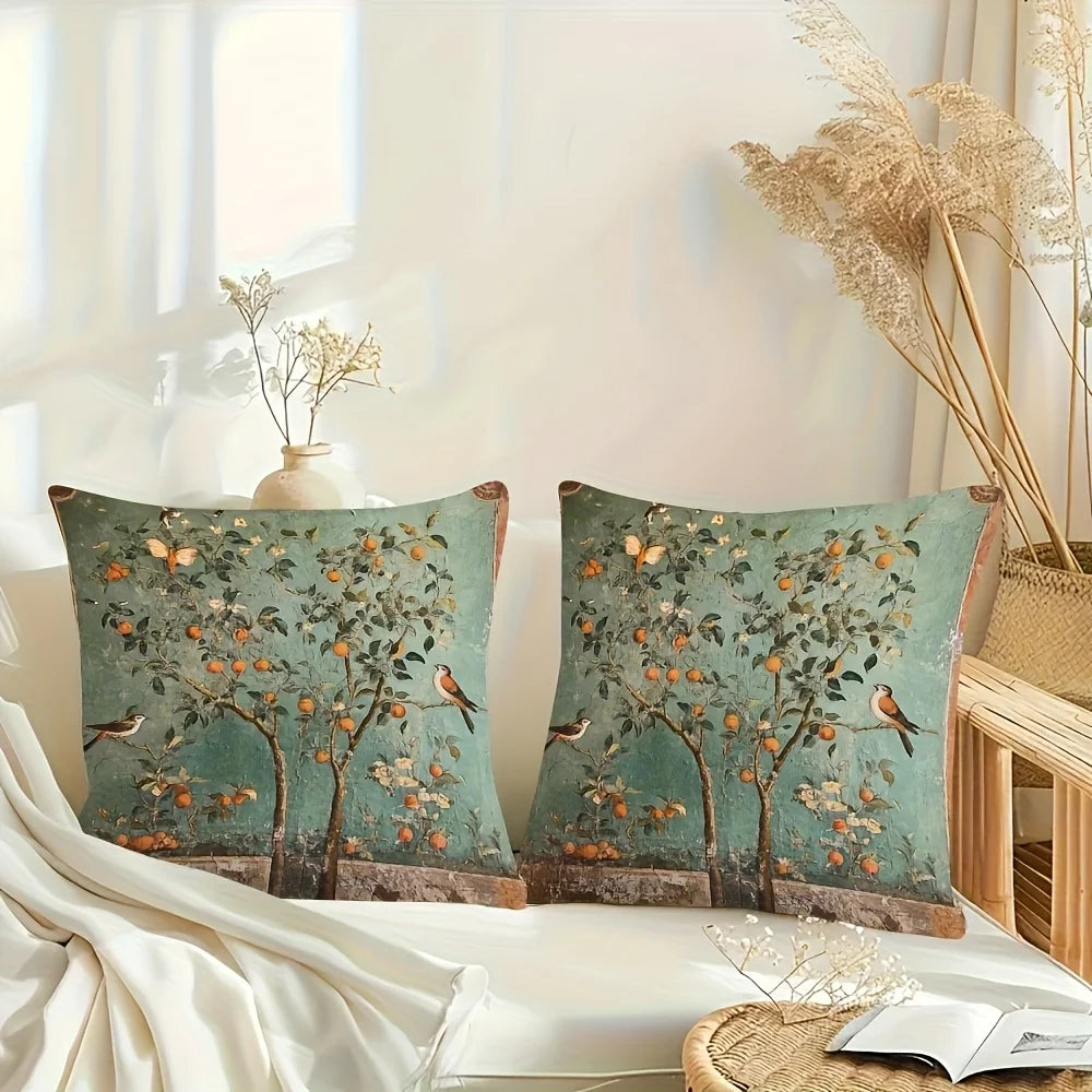 Decorative pillows with tree and bird pattern on a bed