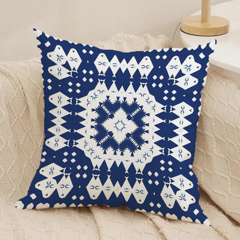 Decorative pillow with blue and white geometric pattern on a beige couch.