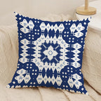 Decorative pillow with blue and white geometric pattern on a beige couch.