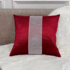 Red pillow with a silver stripe on a white sofa