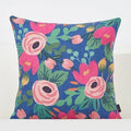 Floral-patterned pillow with pink flowers on a blue background