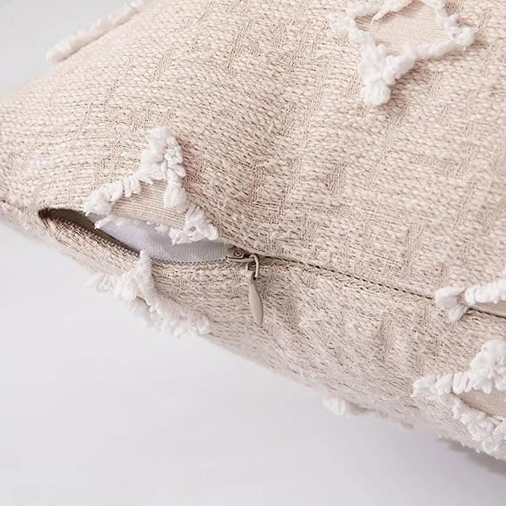 Textured cream throw pillows on wicker seat.