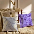 Two decorative pillows with floral patterns on a couch