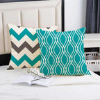 Two decorative pillows with geometric patterns on a bed.