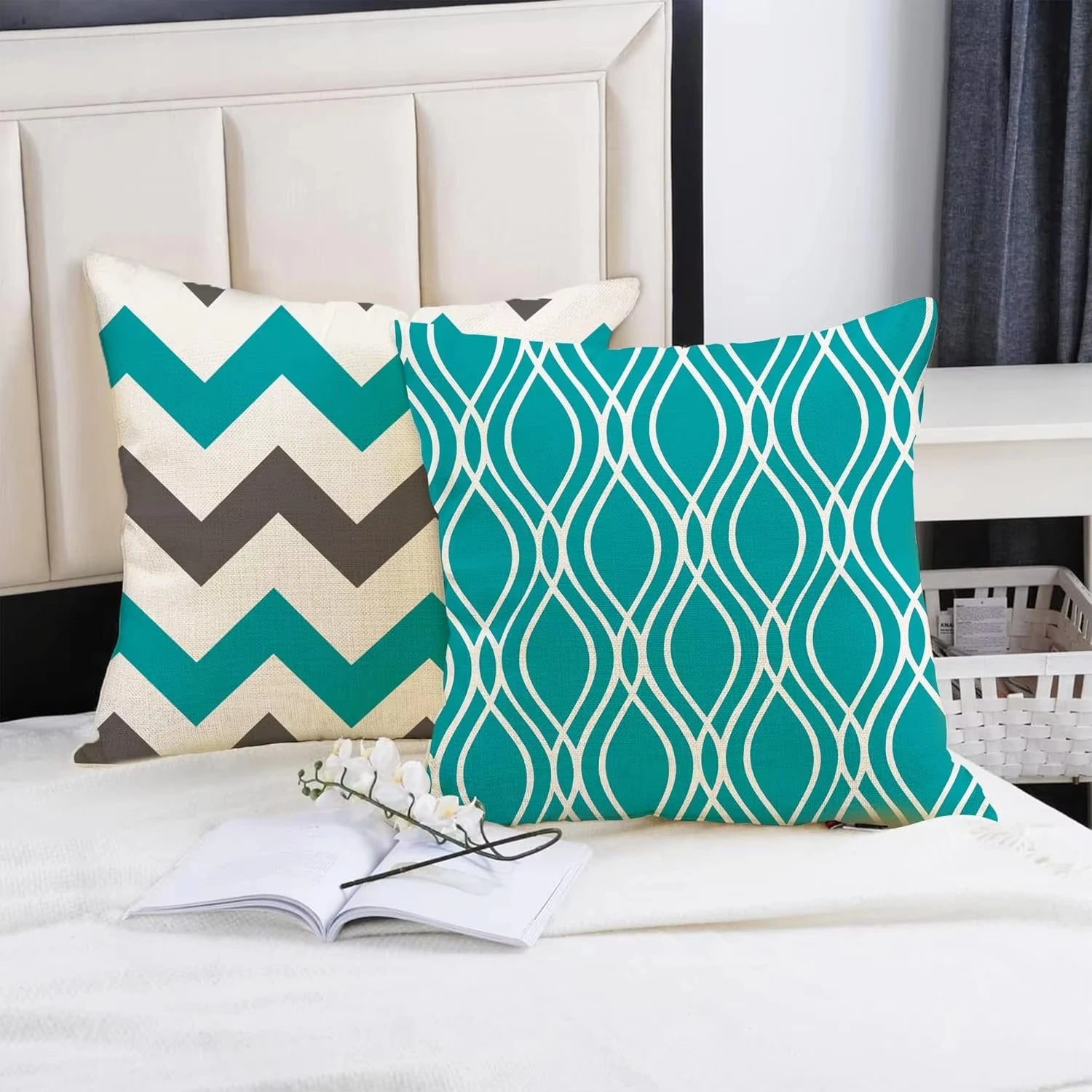 Two decorative pillows with geometric patterns on a bed.