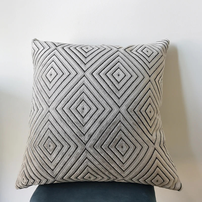 Decorative pillow with geometric pattern on a plain background