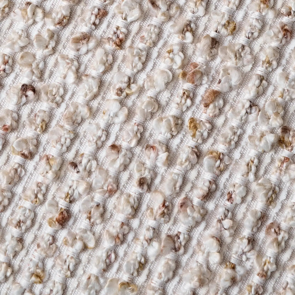 Close-up of textured boucle fabric with woven striped pattern detail
