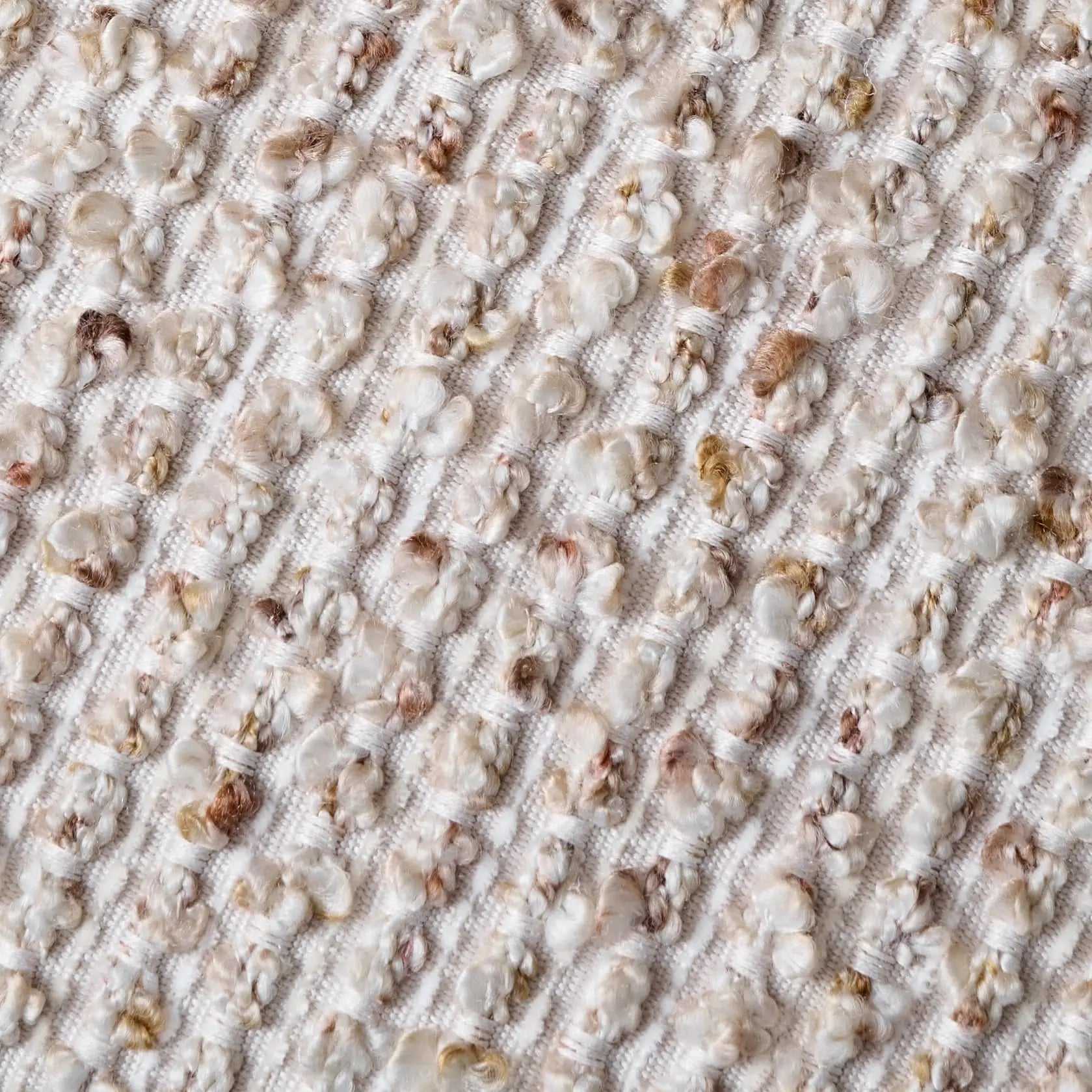 Close-up of textured boucle fabric with woven striped pattern detail