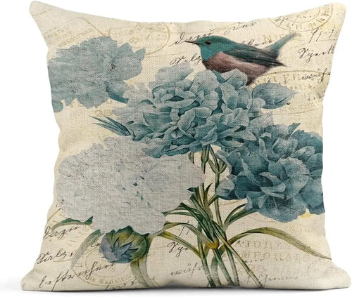 Decorative pillow with floral and bird design on a beige background