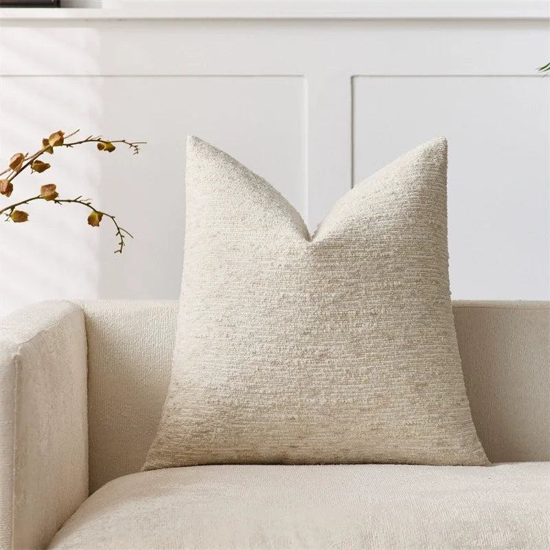 Beige boucle striped pillow cover with textured fabric on sofa