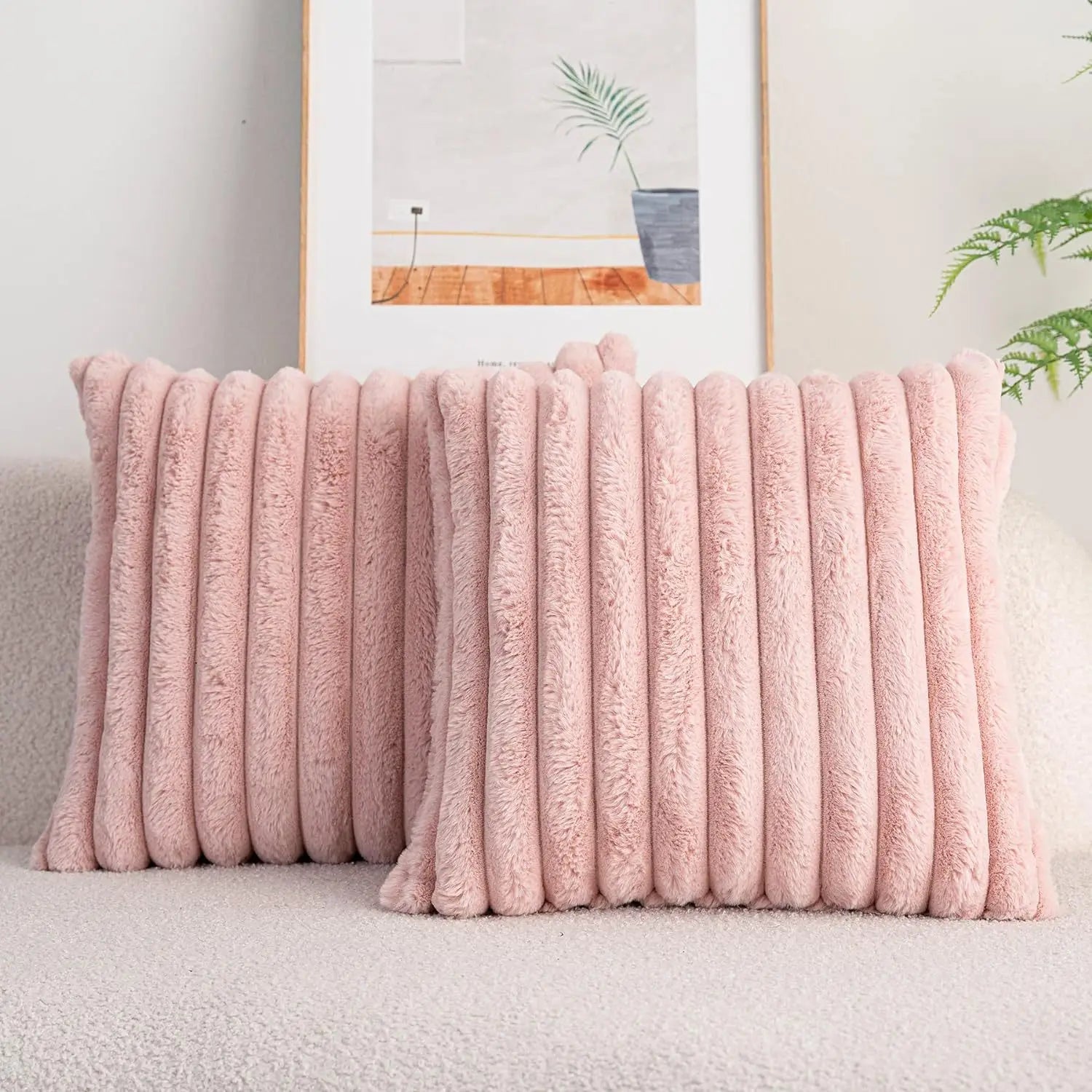 Pink textured throw blanket on a sofa with a neutral background