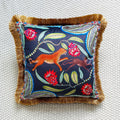 Decorative pillow with animal and floral embroidery on a textured surface