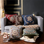 Gray sofa with decorative pillows and a bottle on a dark wall background