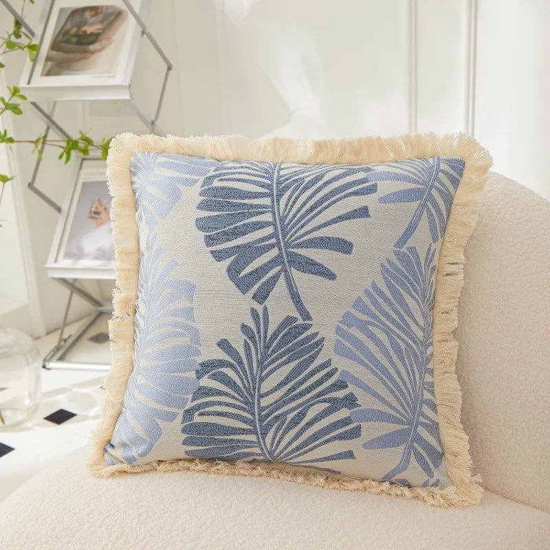 Decorative pillow with leaf pattern on a couch
