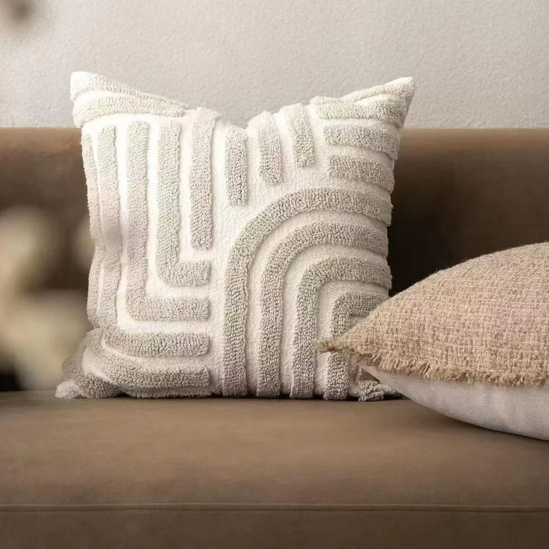 Textured throw pillow on a brown sofa with a neutral background