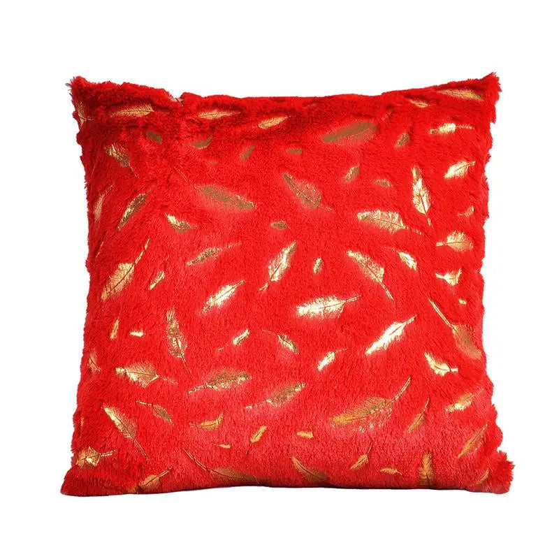 Red pillow with gold leaf pattern on a white background