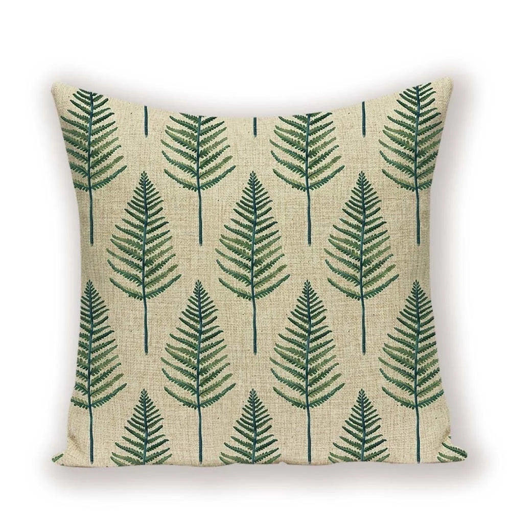 Pillow with green leaf pattern on a beige background