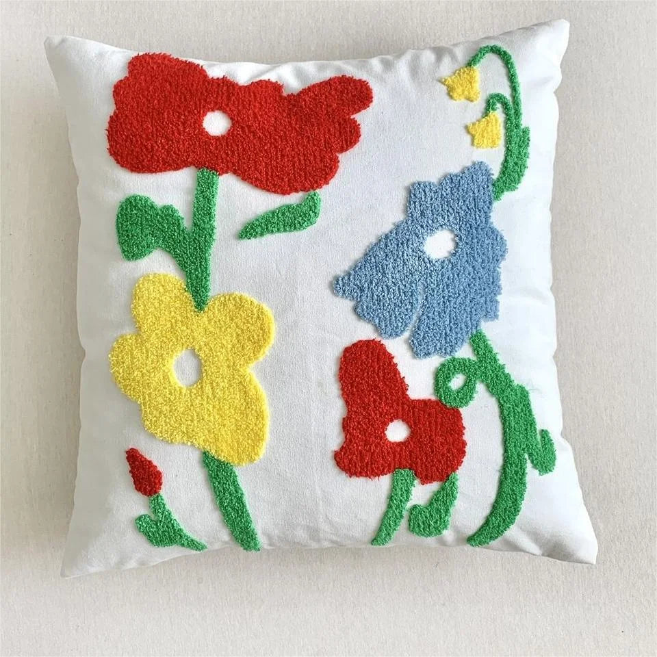 Decorative pillow with colorful floral patterns on a white background