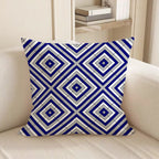Decorative pillow with blue and white geometric pattern on a beige sofa.