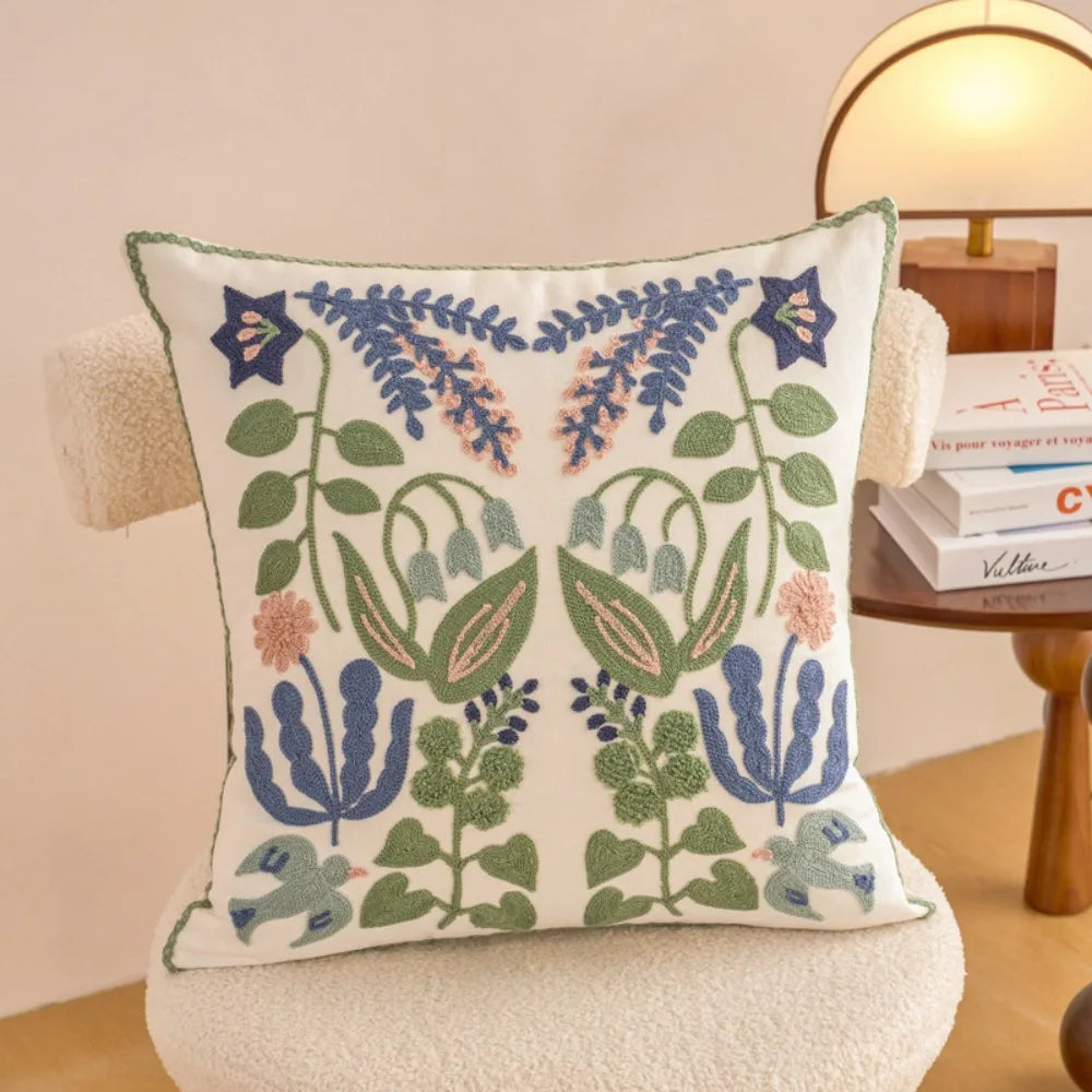 Decorative pillow with floral pattern on a chair in a cozy room.