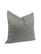 Gray pillow with chevron pattern on a white background
