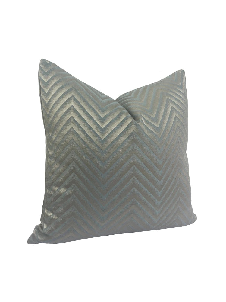Gray pillow with chevron pattern on a white background