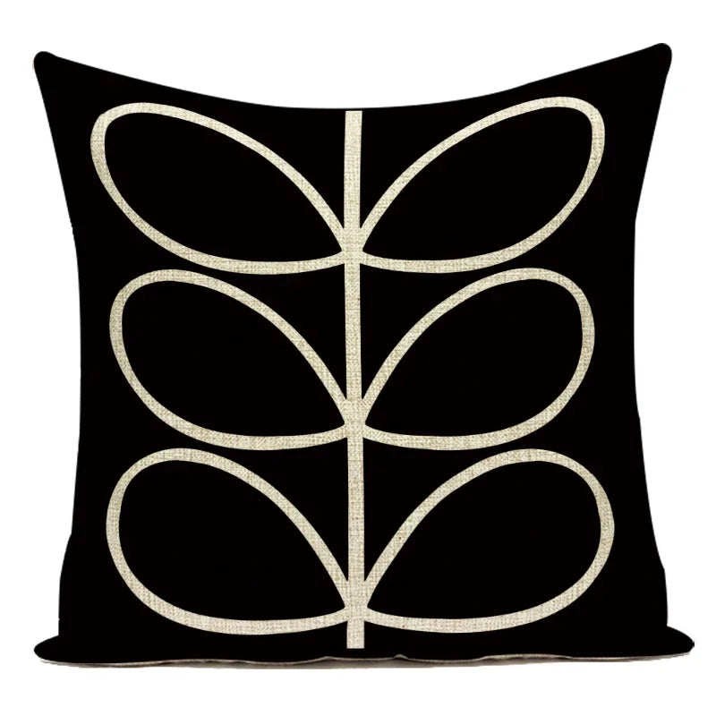 Black pillow with white leaf pattern on a white background