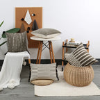 Living room with striped cushions on a wicker stool and table