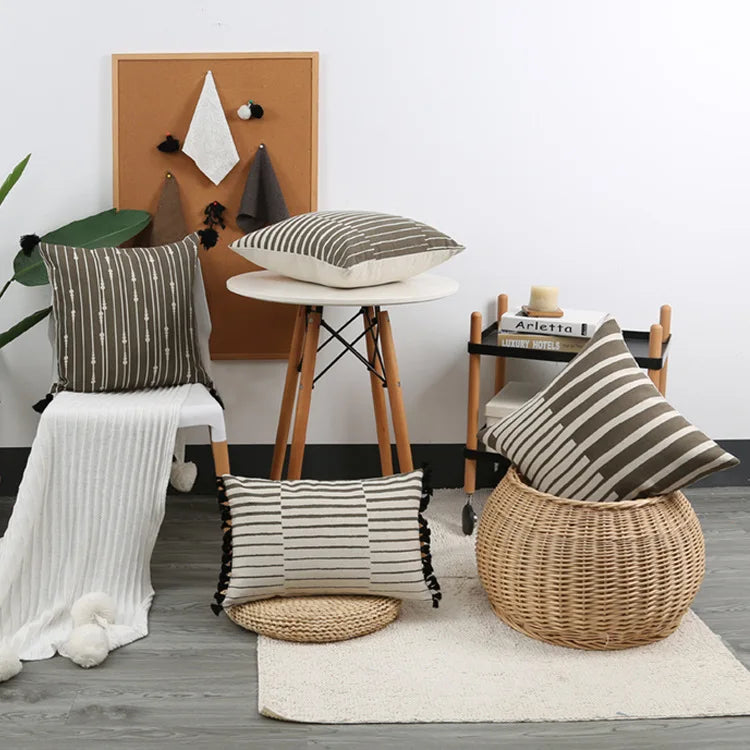 Living room with striped cushions on a wicker stool and table