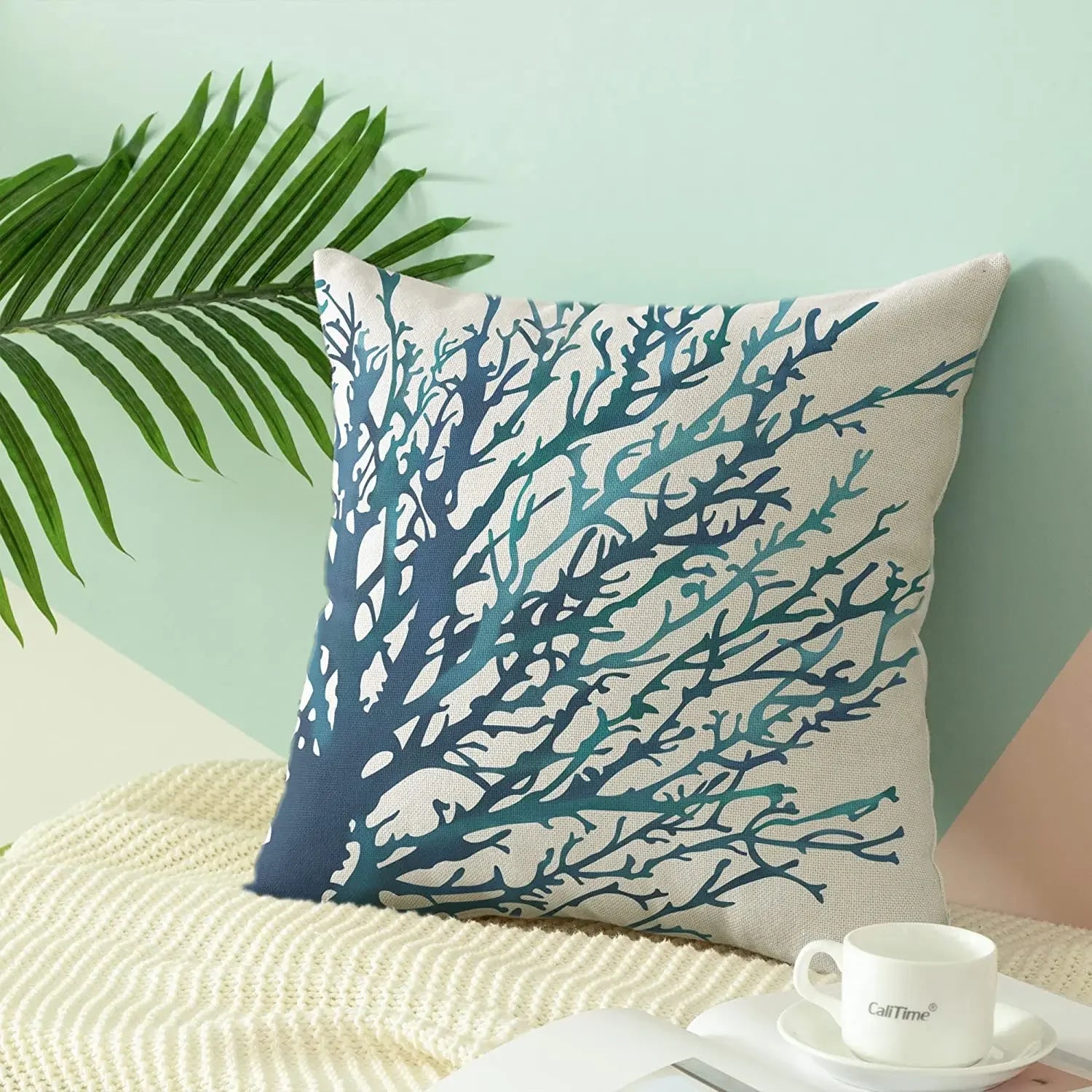 Decorative pillow with blue coral pattern on a light background
